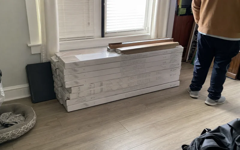 Boxes of laminate acclimating in a room