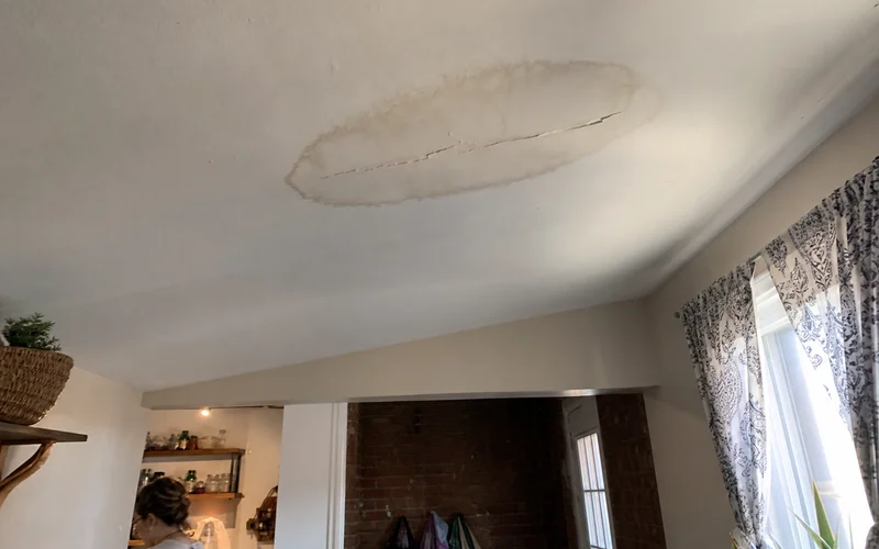 Ceiling with water stain and crack from moisture damage