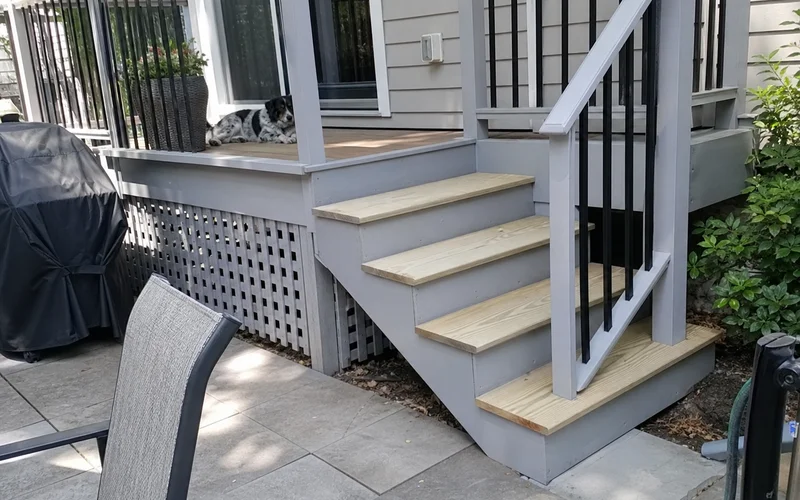 Rebuilt porch stringer, treads, and matched painted trim after carpentry repair