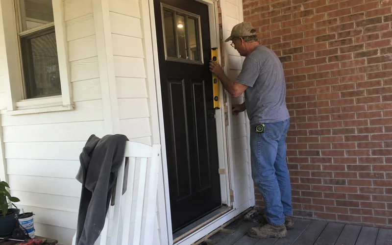 Setting a new prehung exterior door with shims and level