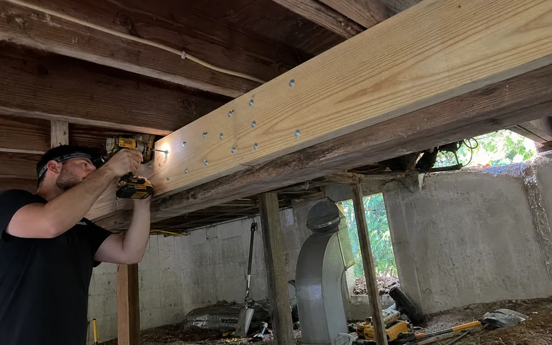 Sistering a new joist alongside a damaged one