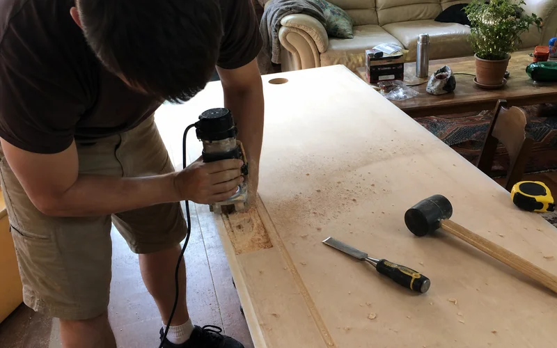 Slab door being cut for new hinge placement