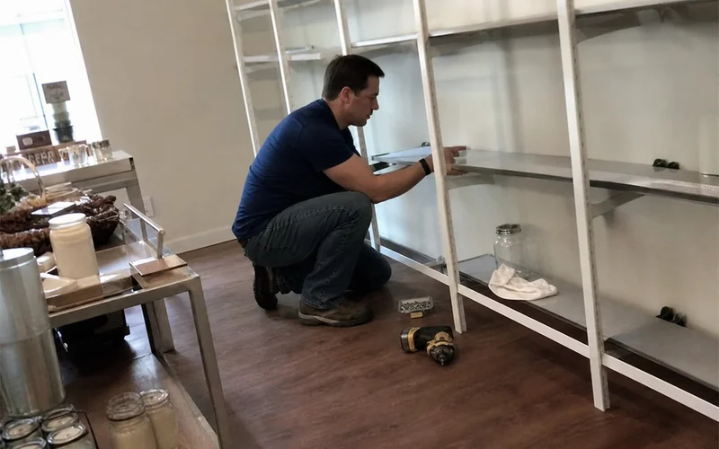 Technician fixing a retail store shelf after hours