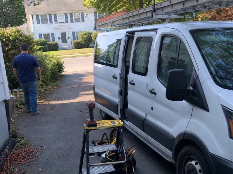 Marked company service van in a West Hartford driveway